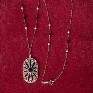 Tiffany and Co. Zeigfeld Collection silver,pearl,and onyx Daisy Pendant.